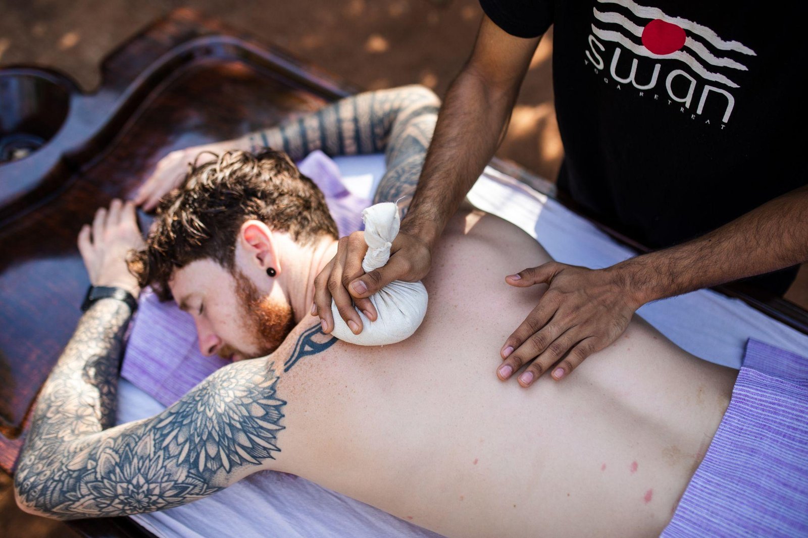 Kizhi — herbal bolus massage on the back, at SWAN Ayurveda