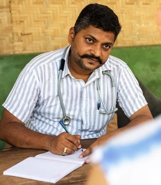 Dr. Siddhesh Bandekar, the resident Ayurvedic physician at SWAN, writing up a consultation